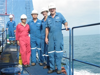 Laura on a platform with her team.