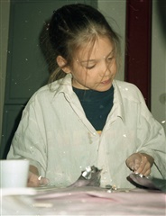Christiane Lederer as a child playing with clay.