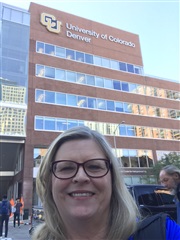 Sandra Cooke standing in front of the University of Colorado building