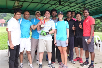 Melissa Ruth standing with the Emerson Cricket Team in Singapore 